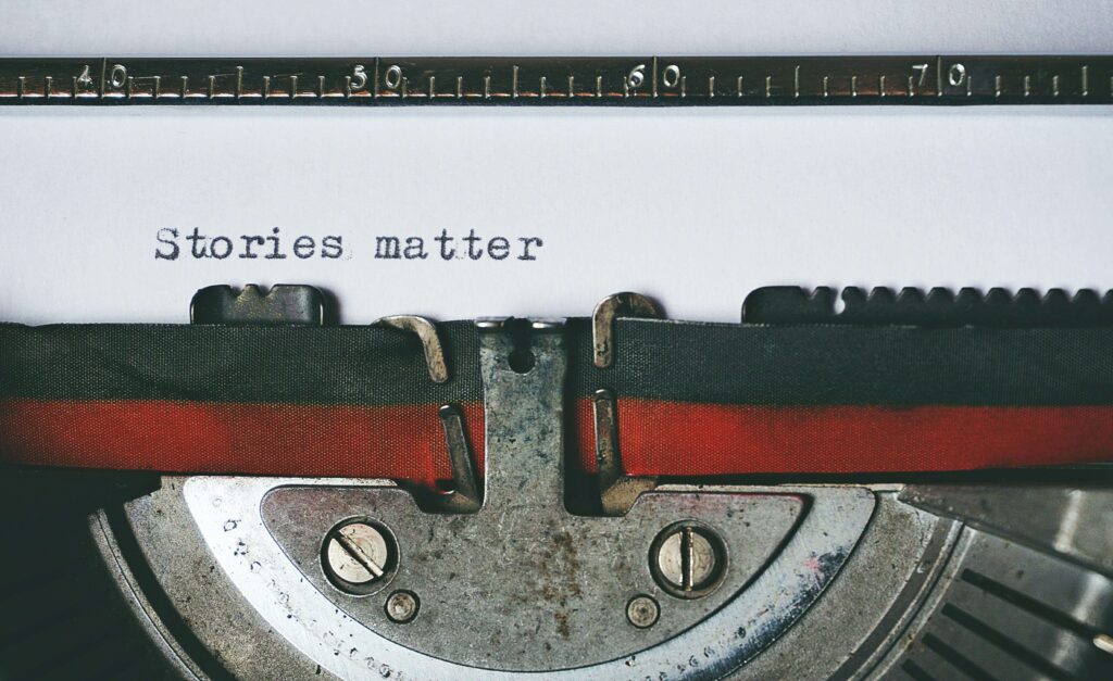 A close up picture of a type writer and and the words "Stories Matter"